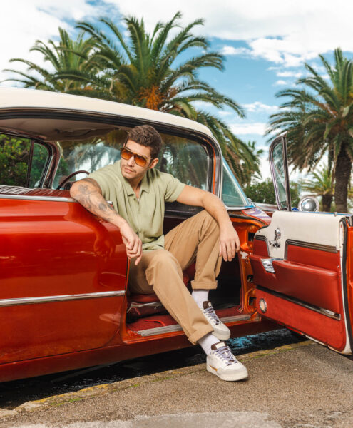 Modello seduto su Cadillac vintage per pubblicità sneakers a San Benedetto del Tronto